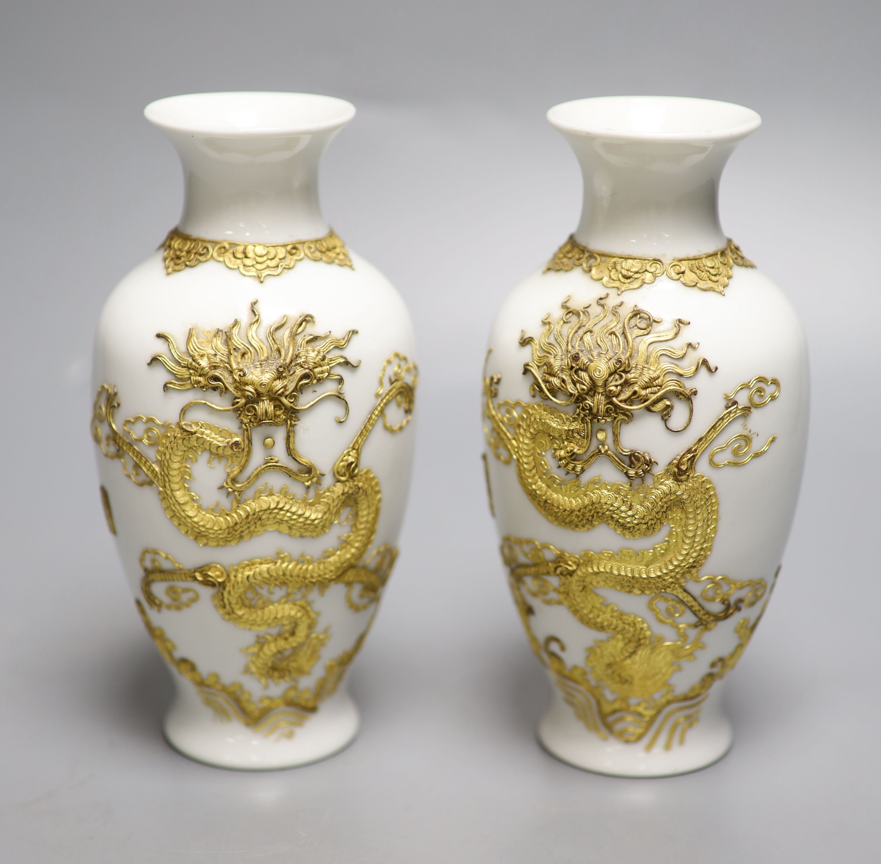 A pair of Chinese blanc de chine vases encrusted with gilt dragons, height 18cm